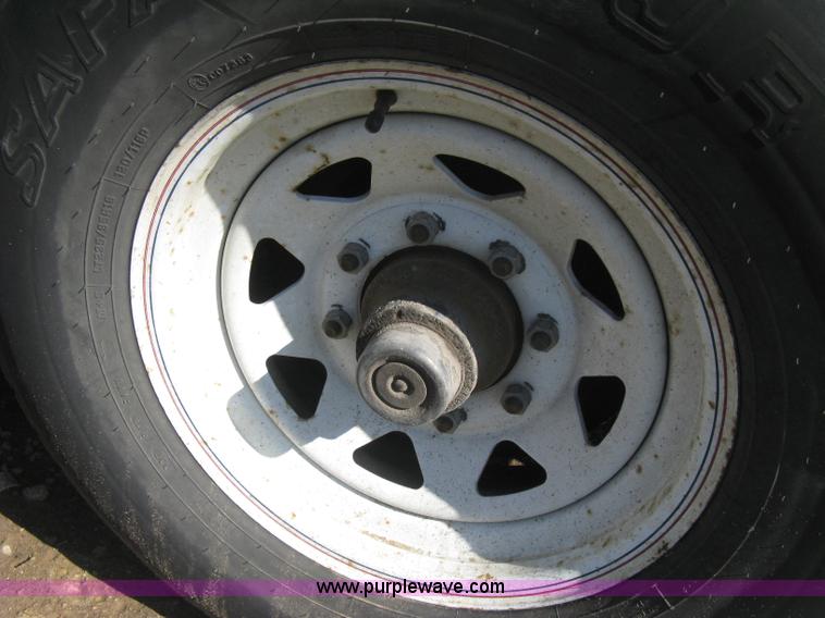 image for item E3381 2004 LB tandem axle flatbed trailer