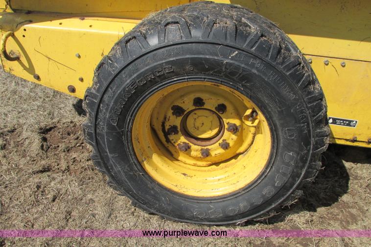 image for item E5062 New Holland LS180 skid steer