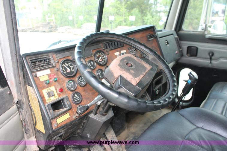 image for item H3580 1998 Peterbilt 320 flatbed truck with knuckle boom crane