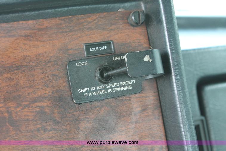 image for item H3580 1998 Peterbilt 320 flatbed truck with knuckle boom crane