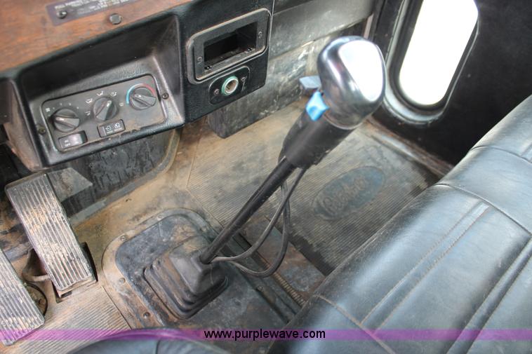 image for item H3580 1998 Peterbilt 320 flatbed truck with knuckle boom crane