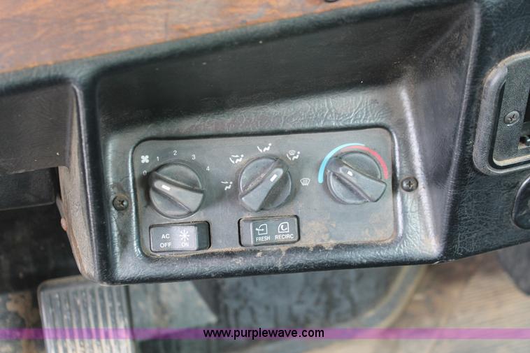 image for item H3580 1998 Peterbilt 320 flatbed truck with knuckle boom crane