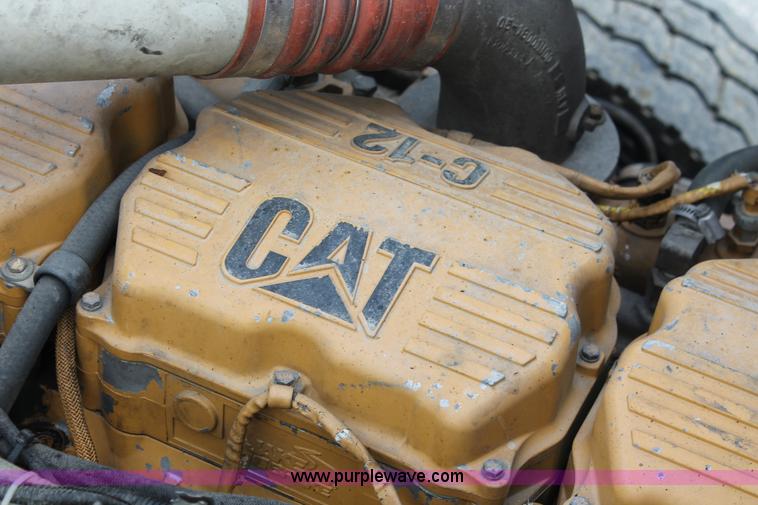 image for item H3580 1998 Peterbilt 320 flatbed truck with knuckle boom crane