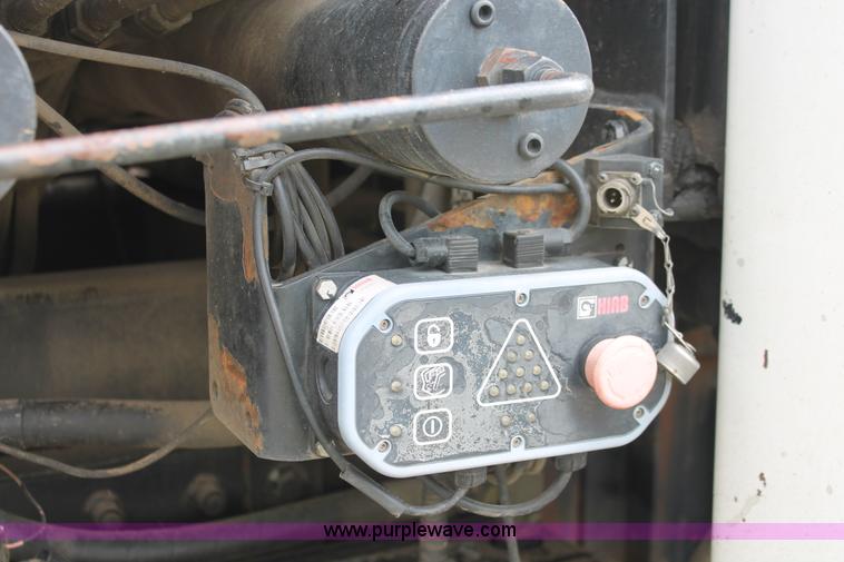 image for item H3580 1998 Peterbilt 320 flatbed truck with knuckle boom crane