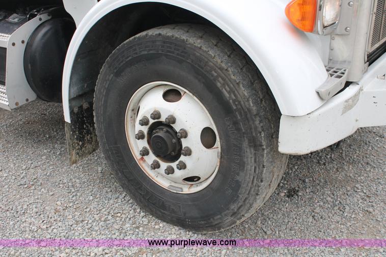 image for item H3580 1998 Peterbilt 320 flatbed truck with knuckle boom crane