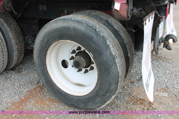 image for item H3580 1998 Peterbilt 320 flatbed truck with knuckle boom crane