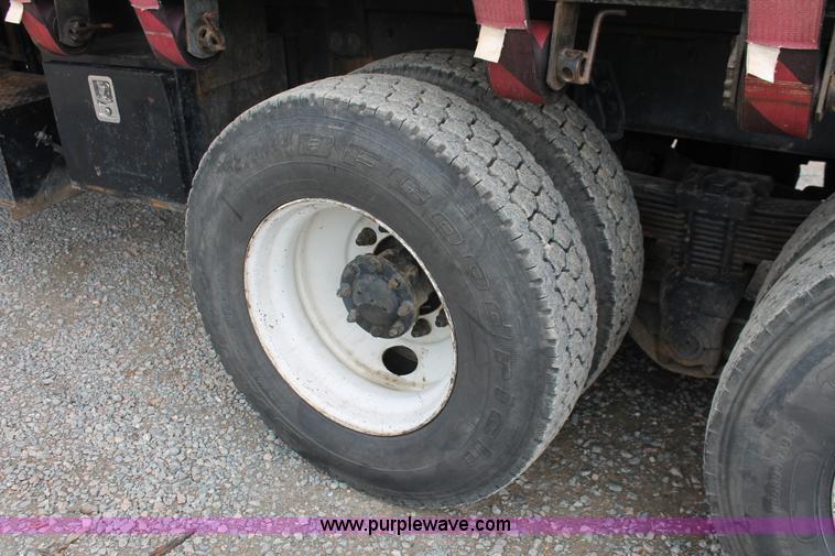 image for item H3580 1998 Peterbilt 320 flatbed truck with knuckle boom crane