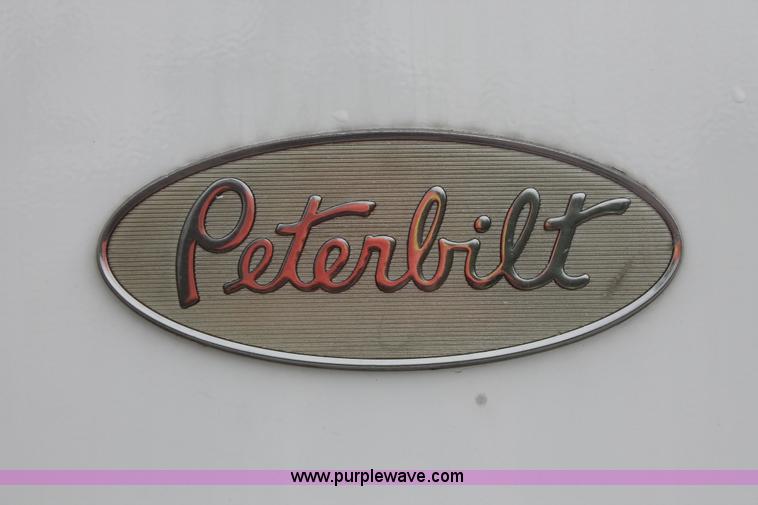 image for item H3580 1998 Peterbilt 320 flatbed truck with knuckle boom crane