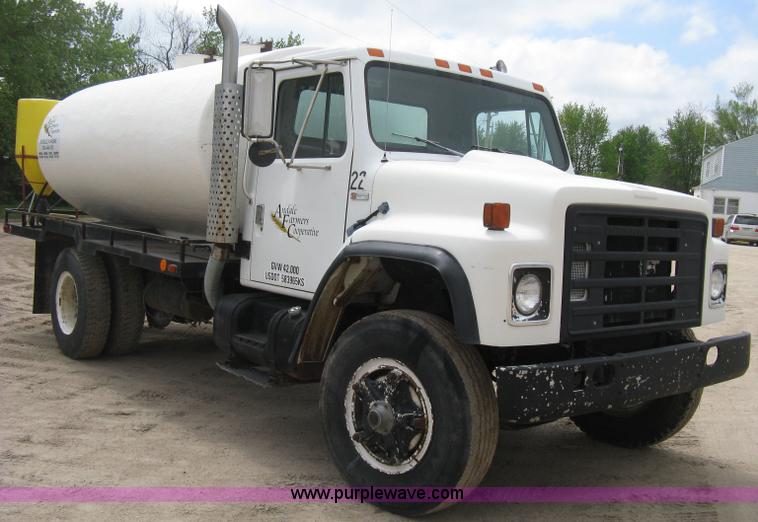 image for item D8299 1982 International 1954 flatbed tender truck