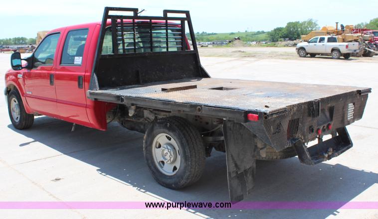 image for item G5496 2005 Ford F350 XL Super Duty Crew Cab flatbed pickup truck