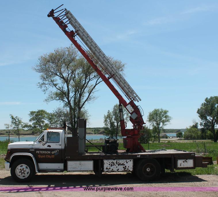 image for item H3087 1977 GMC Sierra 6500 flatbed ladder/boom truck