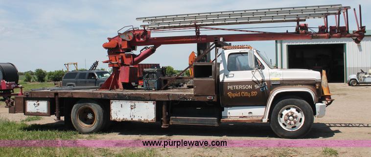 image for item H3087 1977 GMC Sierra 6500 flatbed ladder/boom truck