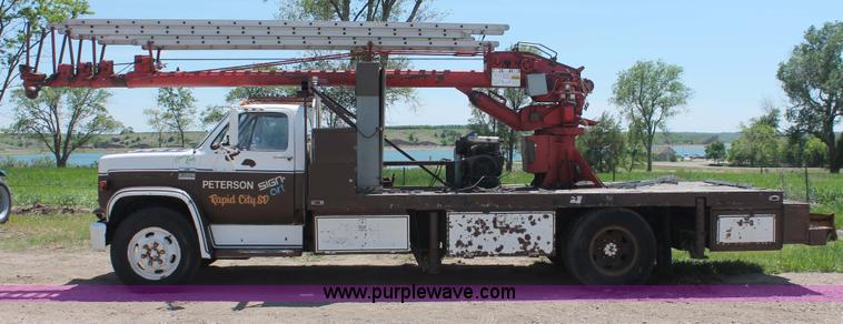 image for item H3087 1977 GMC Sierra 6500 flatbed ladder/boom truck