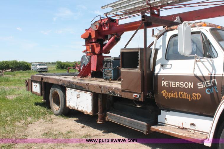 image for item H3087 1977 GMC Sierra 6500 flatbed ladder/boom truck