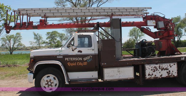 image for item H3087 1977 GMC Sierra 6500 flatbed ladder/boom truck