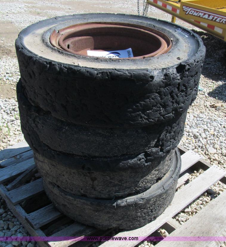 image for item F5093 (4) solid skid steer tires and wheels