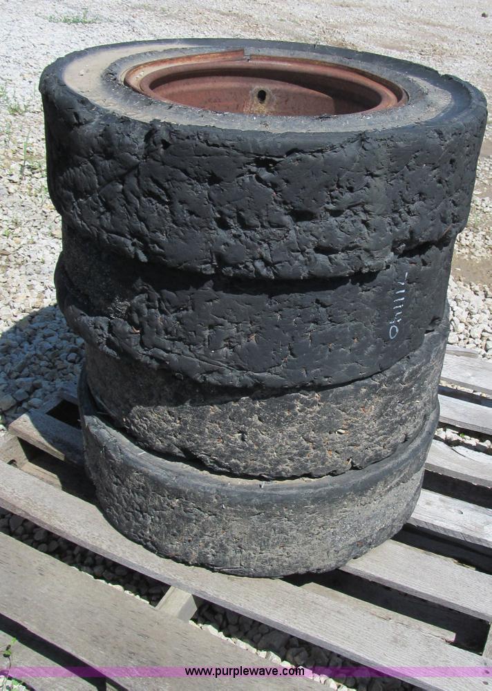 image for item F5093 (4) solid skid steer tires and wheels