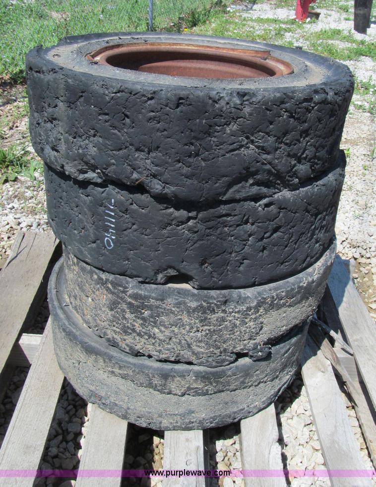 image for item F5093 (4) solid skid steer tires and wheels