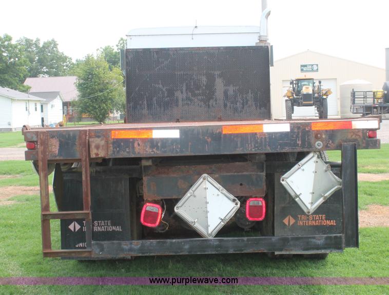 image for item I7895 1982 International Eagle cab over tri axle flatbed truck