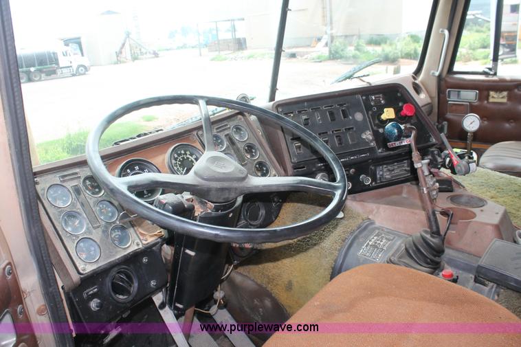 image for item I7895 1982 International Eagle cab over tri axle flatbed truck