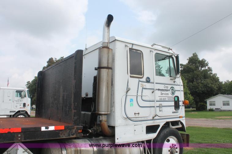 image for item I7895 1982 International Eagle cab over tri axle flatbed truck