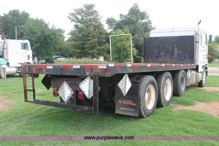 image for item I7895 1982 International Eagle cab over tri axle flatbed truck