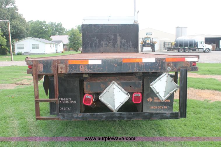 image for item I7895 1982 International Eagle cab over tri axle flatbed truck