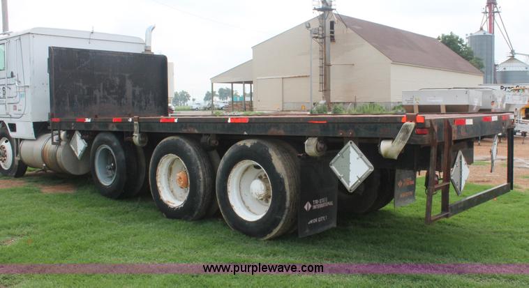 image for item I7895 1982 International Eagle cab over tri axle flatbed truck