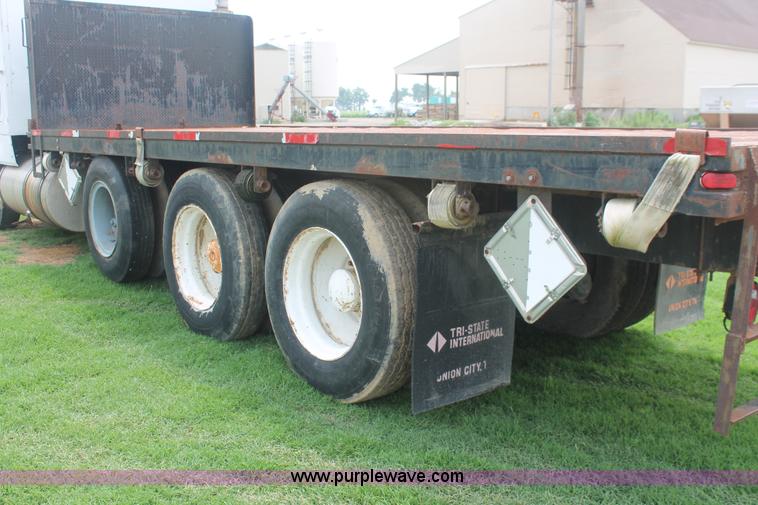 image for item I7895 1982 International Eagle cab over tri axle flatbed truck