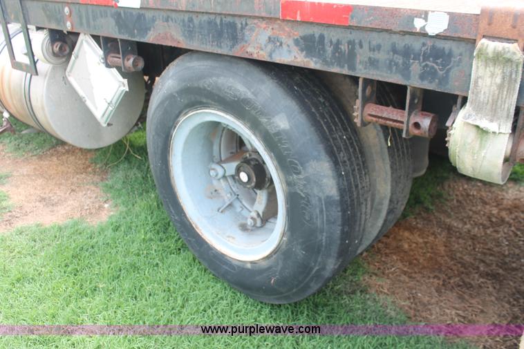 image for item I7895 1982 International Eagle cab over tri axle flatbed truck