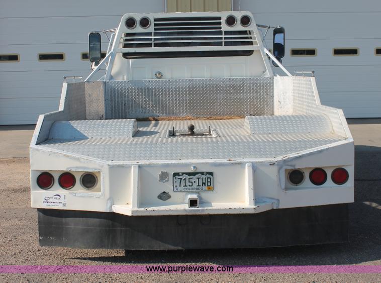 image for item I7948 1990 Ford F700 flatbed hauler truck