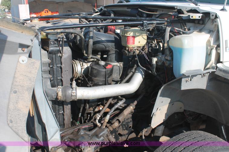 image for item I7948 1990 Ford F700 flatbed hauler truck