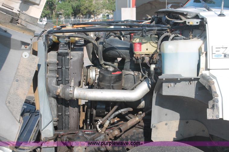 image for item I7948 1990 Ford F700 flatbed hauler truck