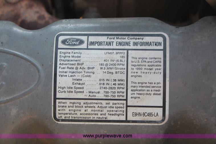 image for item I7948 1990 Ford F700 flatbed hauler truck