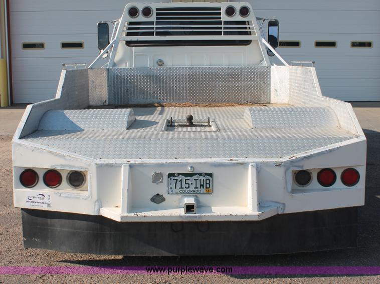 image for item I7948 1990 Ford F700 flatbed hauler truck