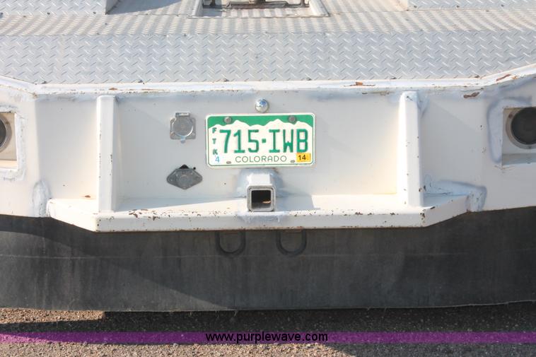 image for item I7948 1990 Ford F700 flatbed hauler truck