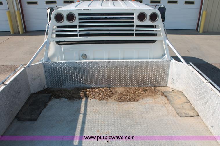 image for item I7948 1990 Ford F700 flatbed hauler truck