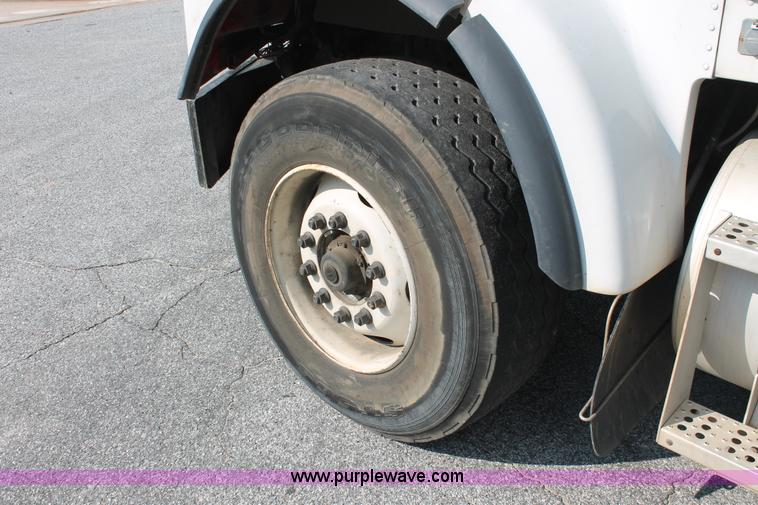 image for item I7757 2002 Freightliner FLD120SD triple axle semi truck with Palfinger knuckle boom crane