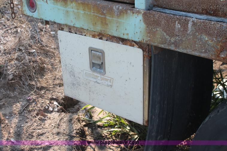 image for item I8245 2000 International 4700 Lo-Profile flatbed/crane body truck