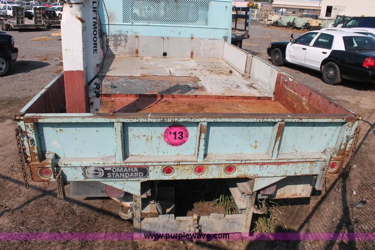 image for item I8245 2000 International 4700 Lo-Profile flatbed/crane body truck