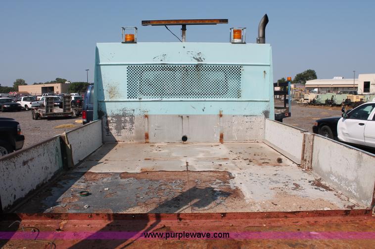 image for item I8245 2000 International 4700 Lo-Profile flatbed/crane body truck