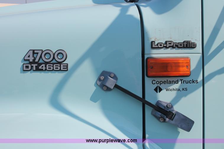 image for item I8245 2000 International 4700 Lo-Profile flatbed/crane body truck