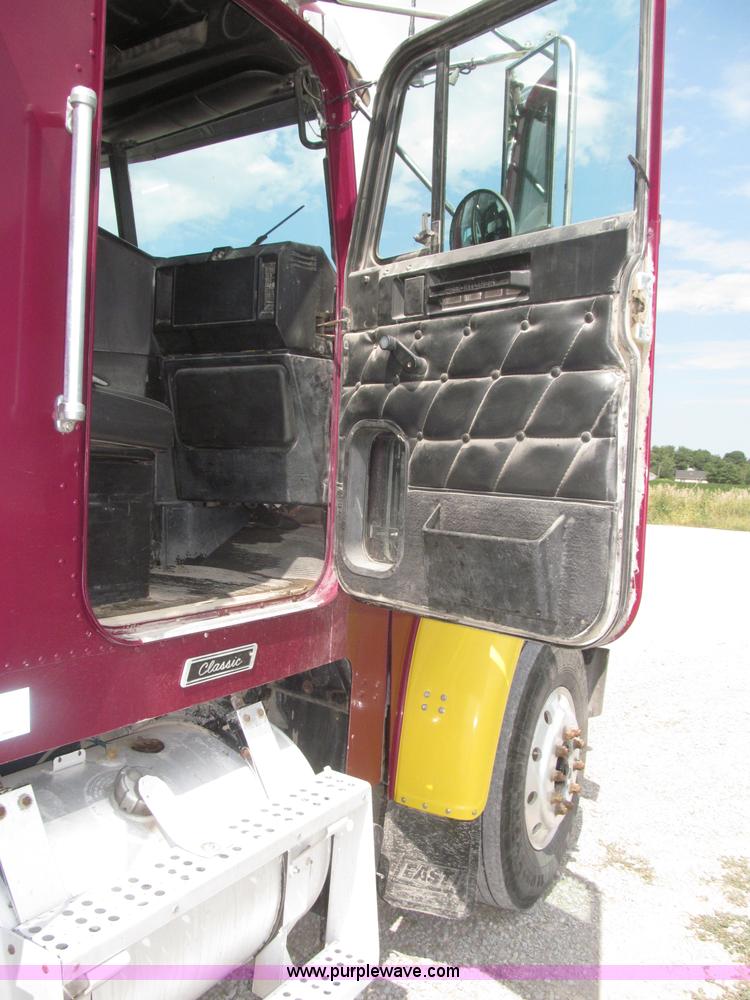 image for item F7111 2000 Freightliner FLD120SD tri axle dump truck