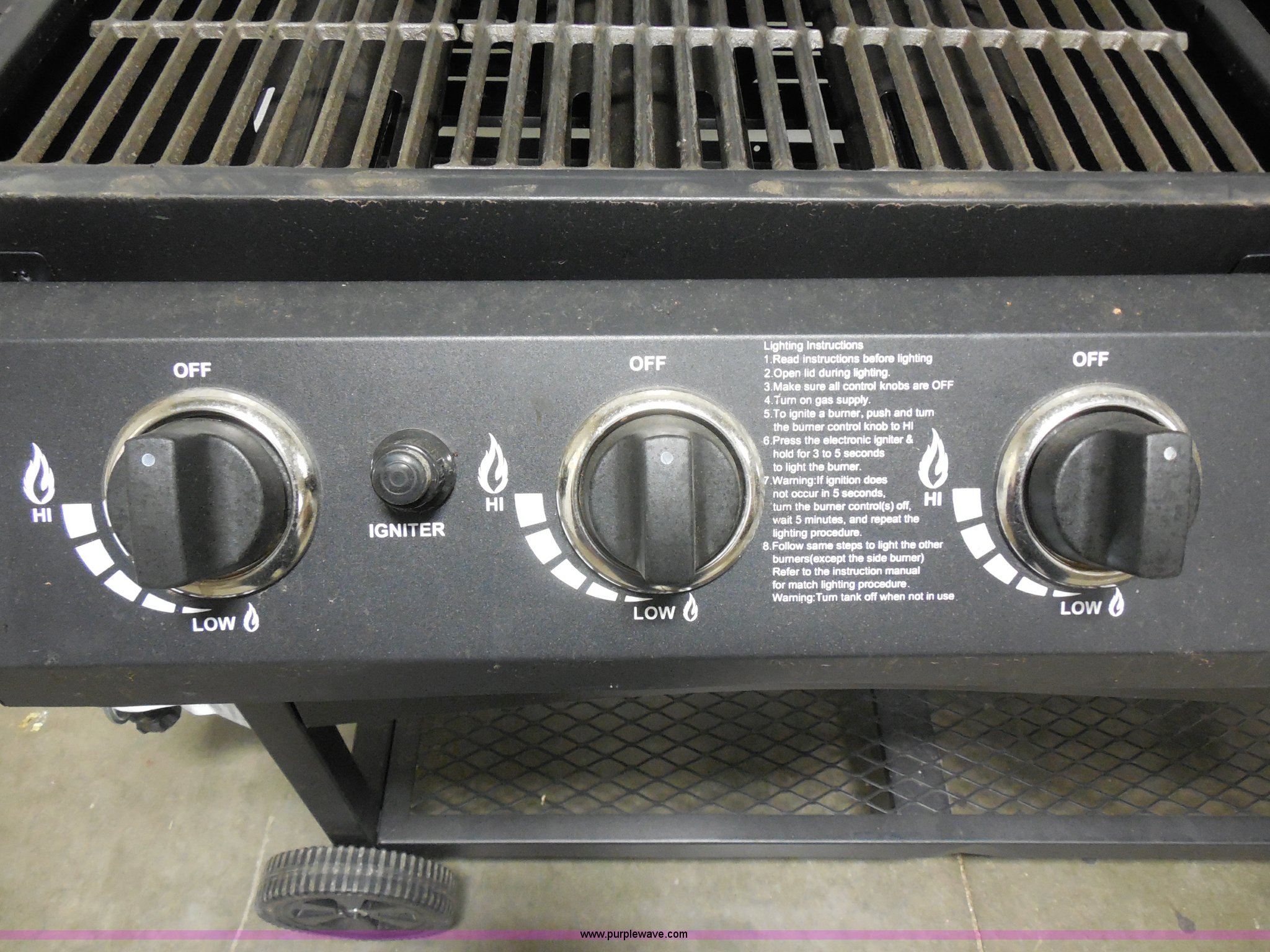Outdoor Gourmet Triton four burner propane and charcoal grill in