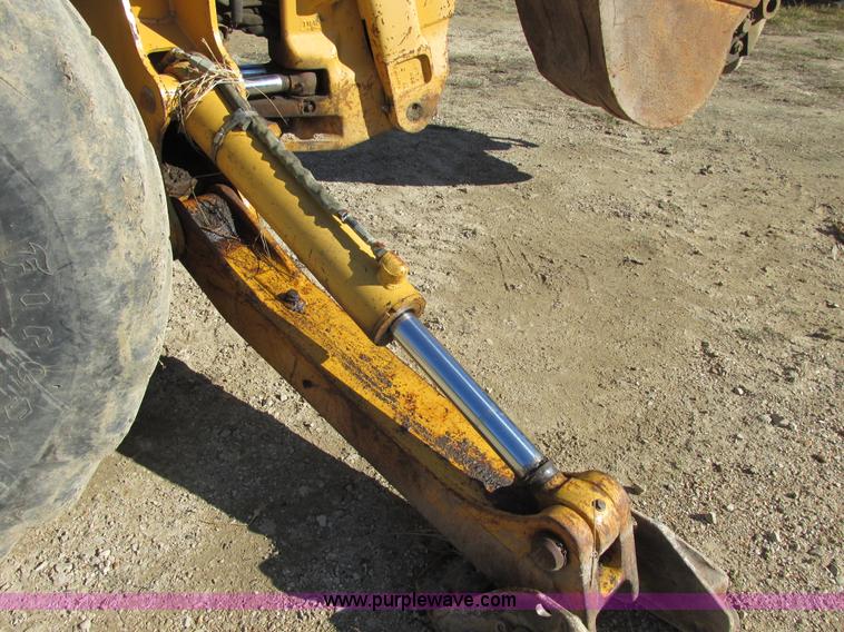 image for item E7409 2000 John Deere 710D backhoe