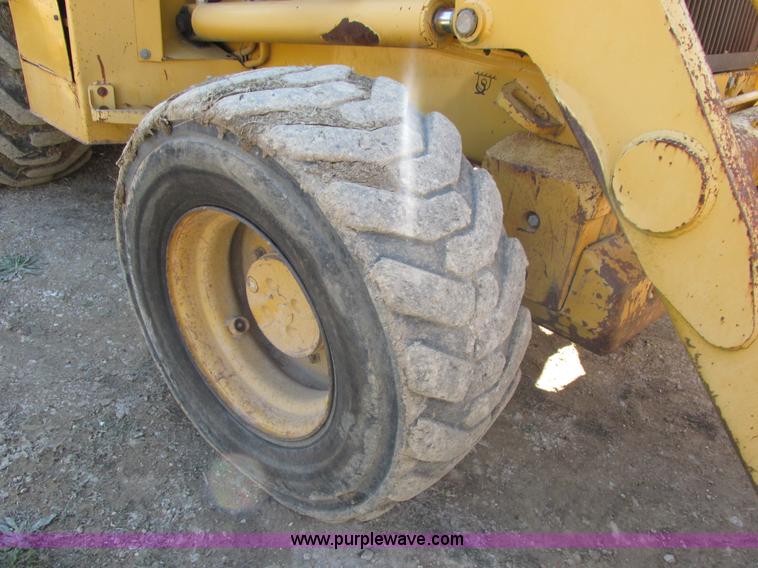 image for item E7409 2000 John Deere 710D backhoe