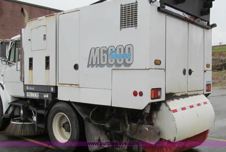 image for item G2173 2003 Freightliner FL70 truck with Schwarze M6000 sweeper