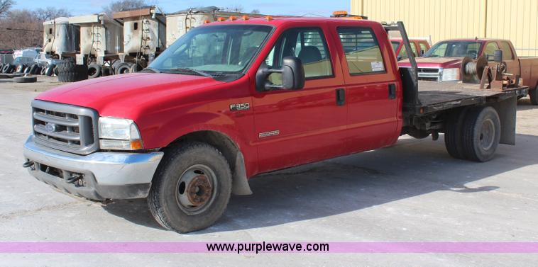 image for item H7876 2004 Ford F350 Crew Cab flatbed pickup truck