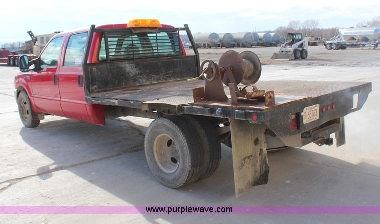 image for item H7876 2004 Ford F350 Crew Cab flatbed pickup truck