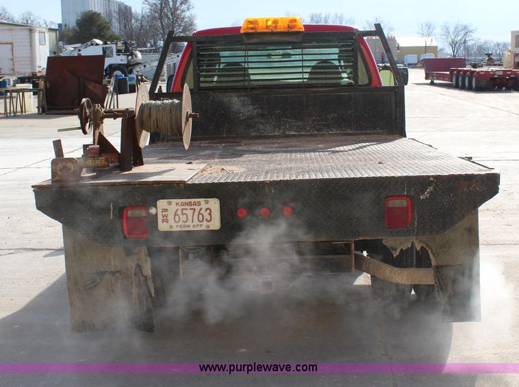 image for item H7876 2004 Ford F350 Crew Cab flatbed pickup truck